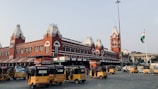 a group of yellow buses parked in front of a building