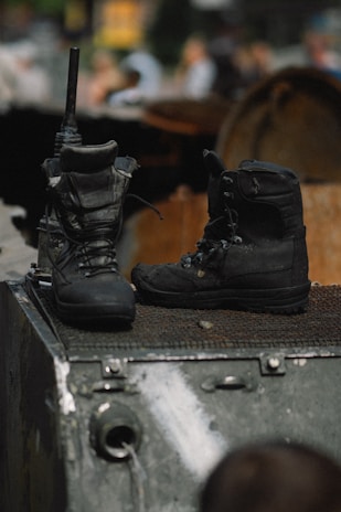 a pair of boots on top of a suitcase