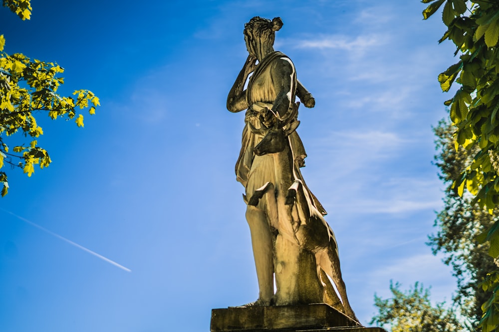 a statue of a person holding a staff