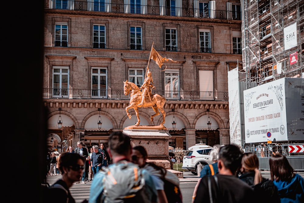 a statue of a person on a horse in a city