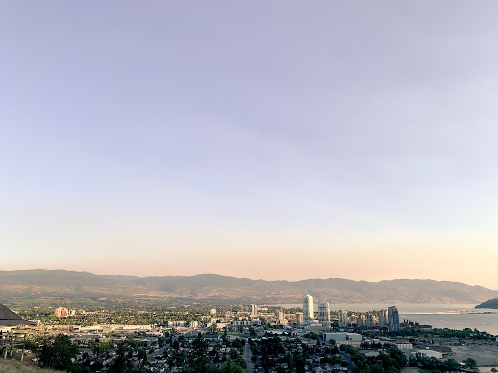 a city with a body of water in the background