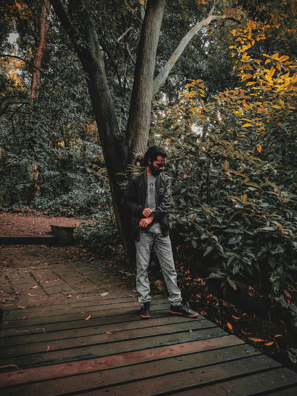 a man standing on a wooden bridge