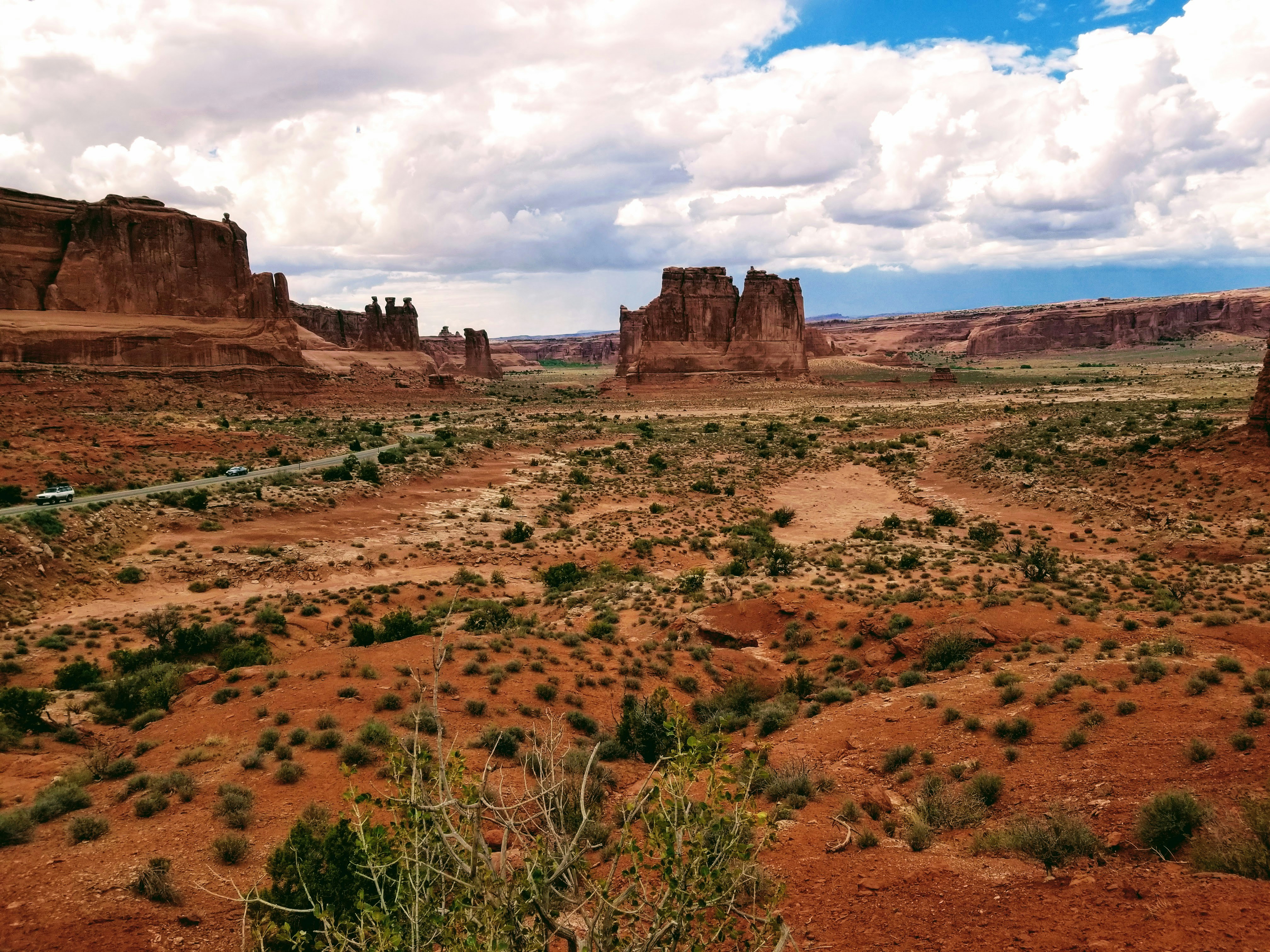 a desert landscape with a few large rocks in the distance
