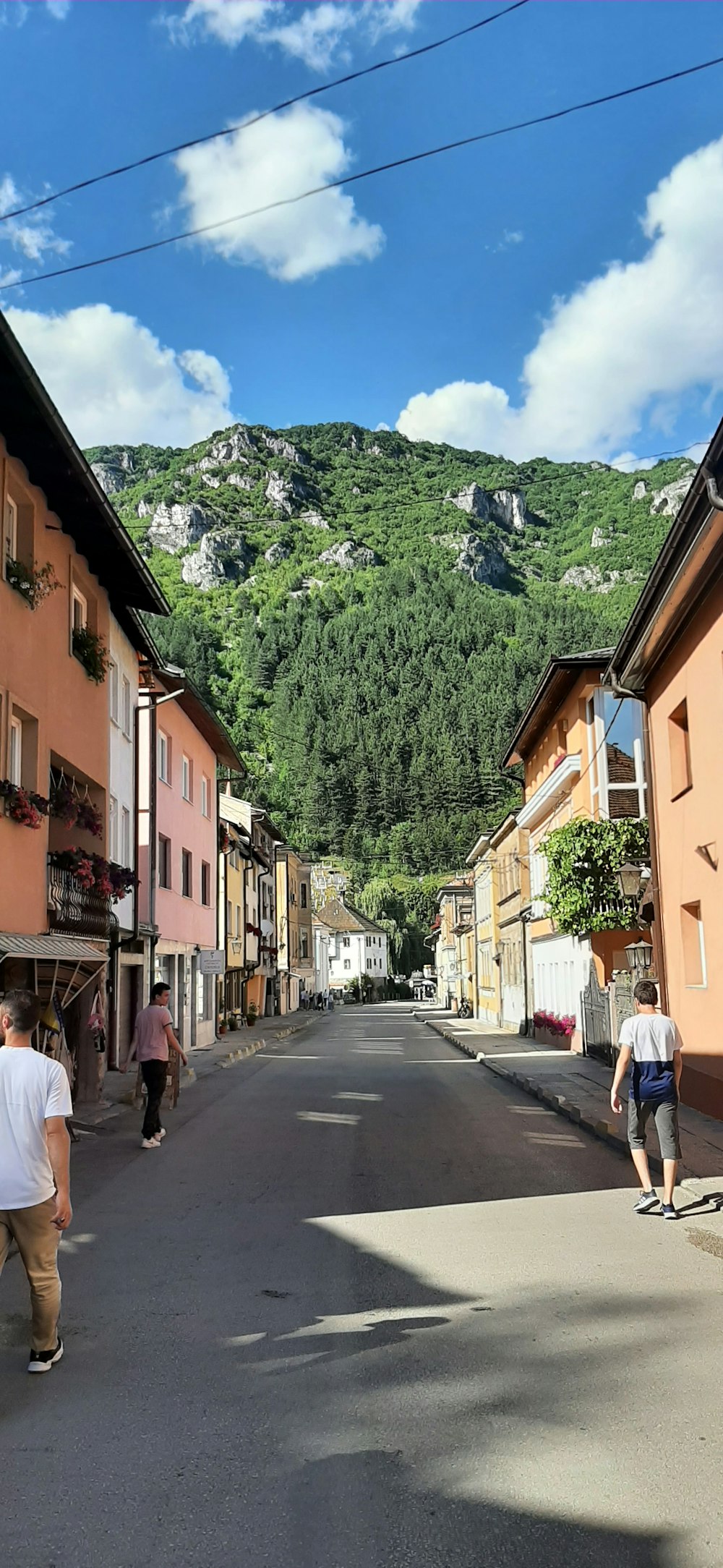 a street with buildings and a hill in the background