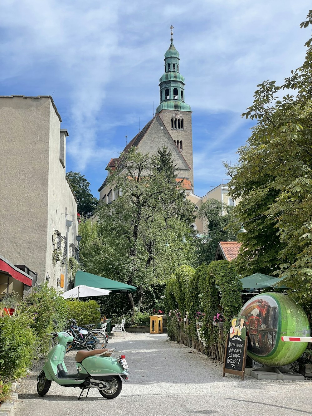 a green scooter parked in front of a castle