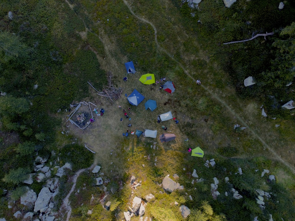 a group of tents on a grassy hill