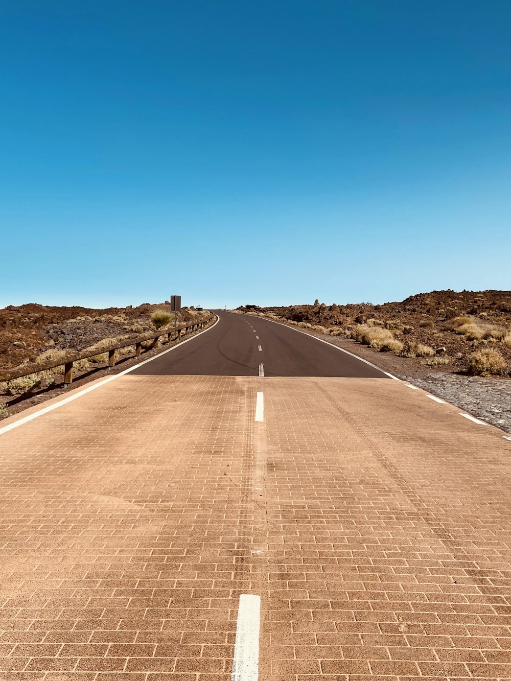 a road with a brick walkway