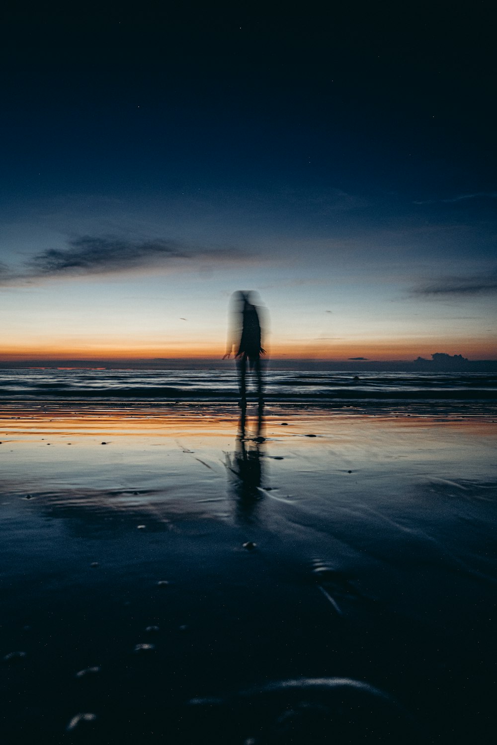 a person holding a surfboard on a beach