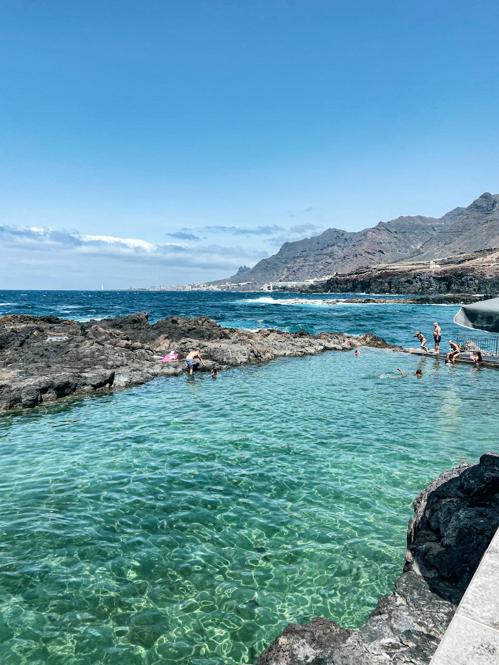 people swimming in a blue water