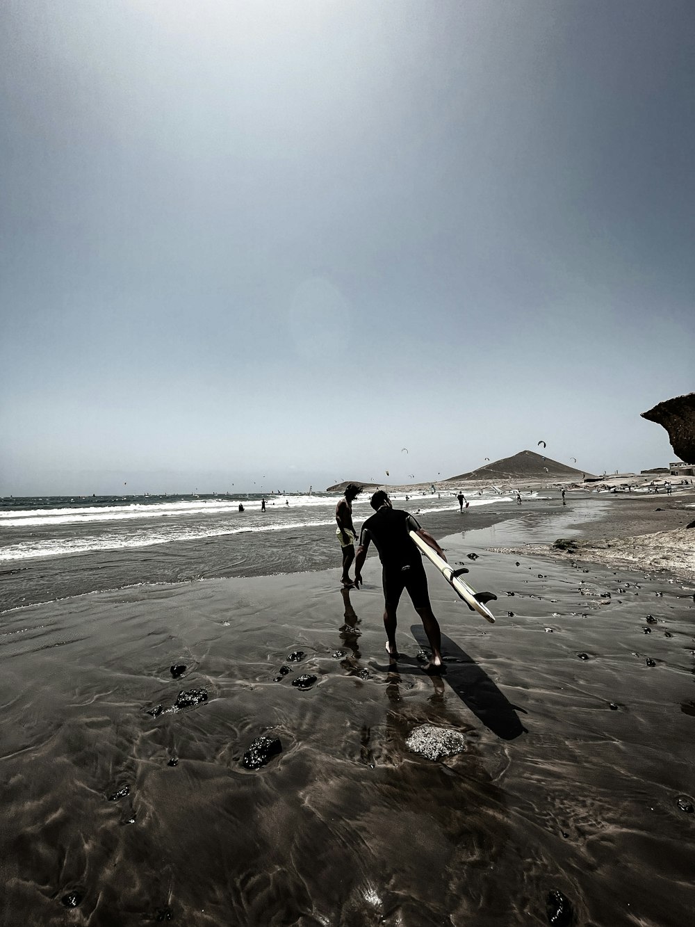 a group of people stand on a beach