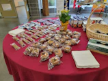 Youth volunteers setting up a bake sale table with colorful signs.