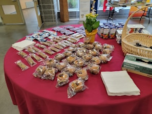 A stylish catering table at an office event with neatly presented thematic snack packs