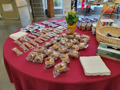 A lively bake sale table filled with homemade treats and smiling volunteers.