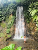 a person standing in front of a waterfall