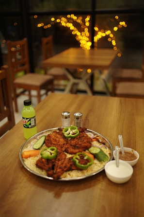 A warm, inviting dining table set with Royal Chicken and Grill's signature dishes ready to be enjoyed.