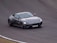 A sleek sports car racing on a winding road, showcasing speed and excitement.