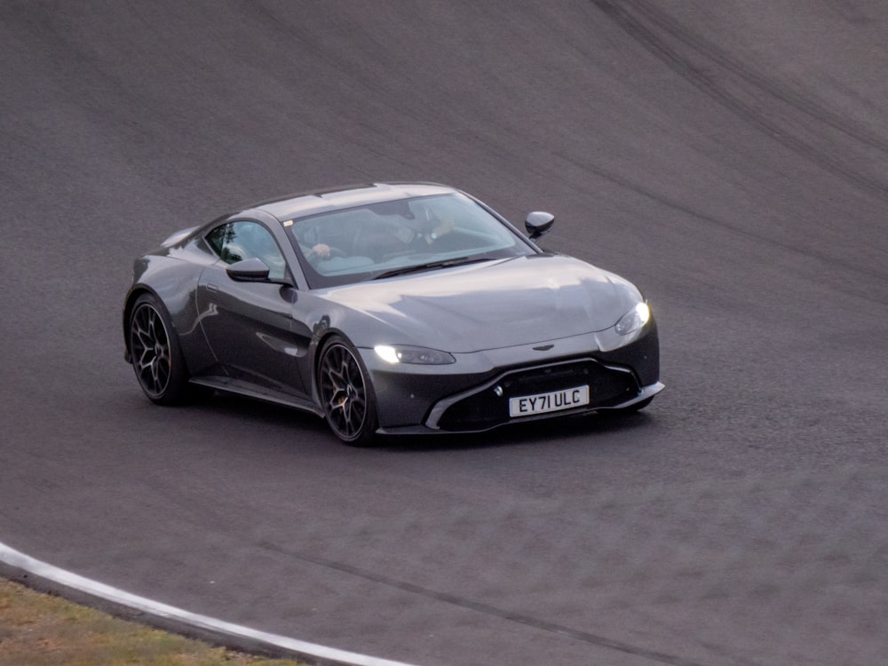 a silver sports car on a race track