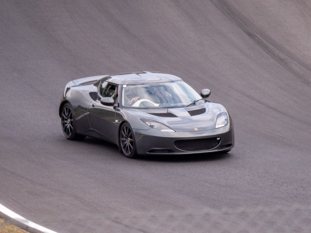 a silver sports car on a road