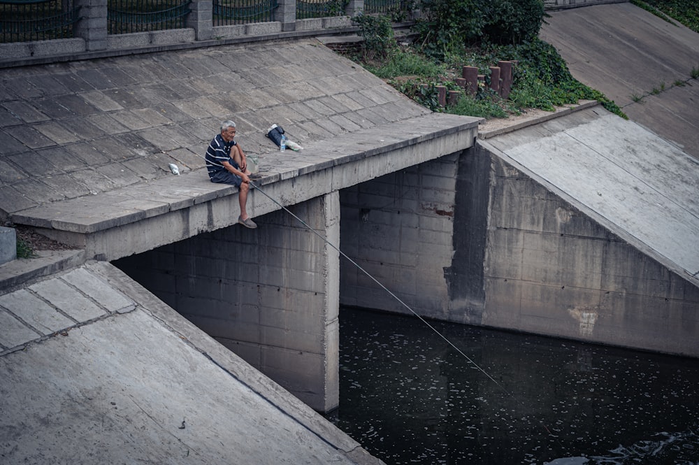 a man sitting on a concrete ledge
