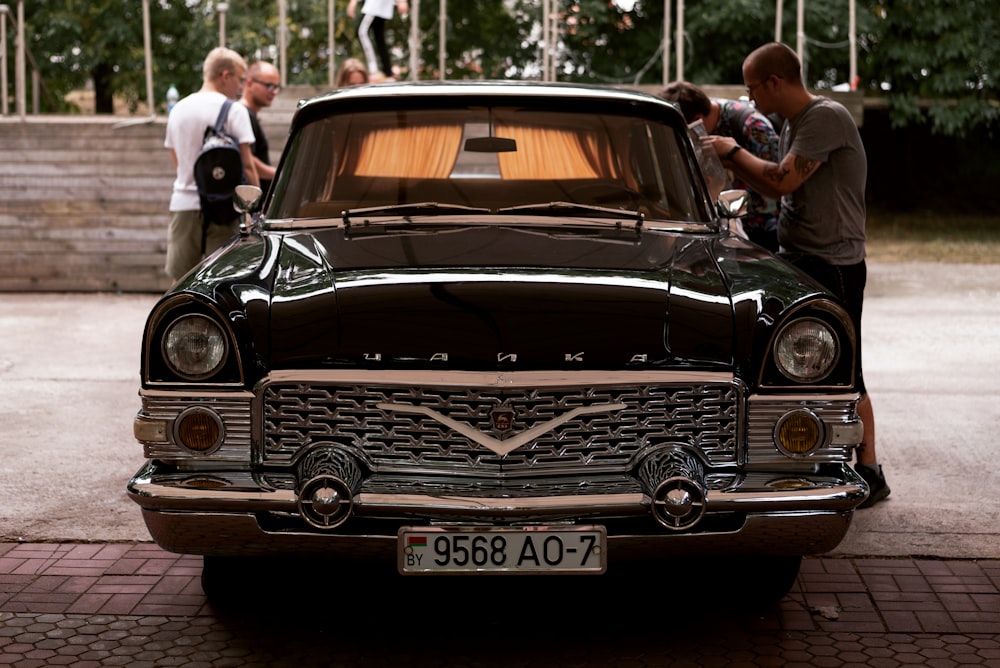 a man standing next to a car