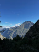 A majestic mountain landscape with clear blue skies and lush greenery