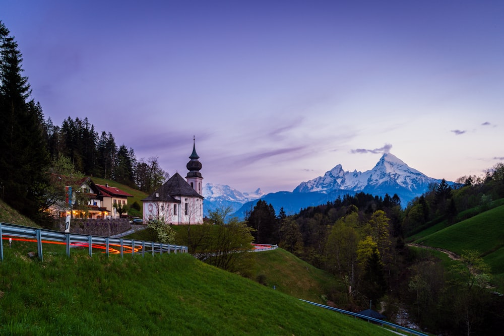 a building on a hill with a mountain in the background