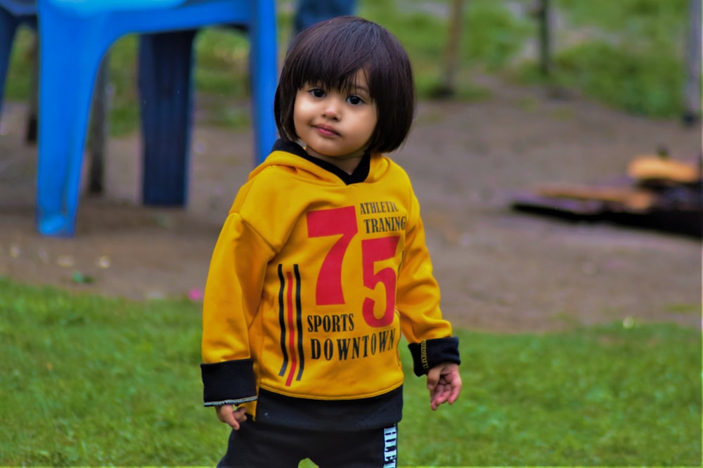 a child in a yellow shirt