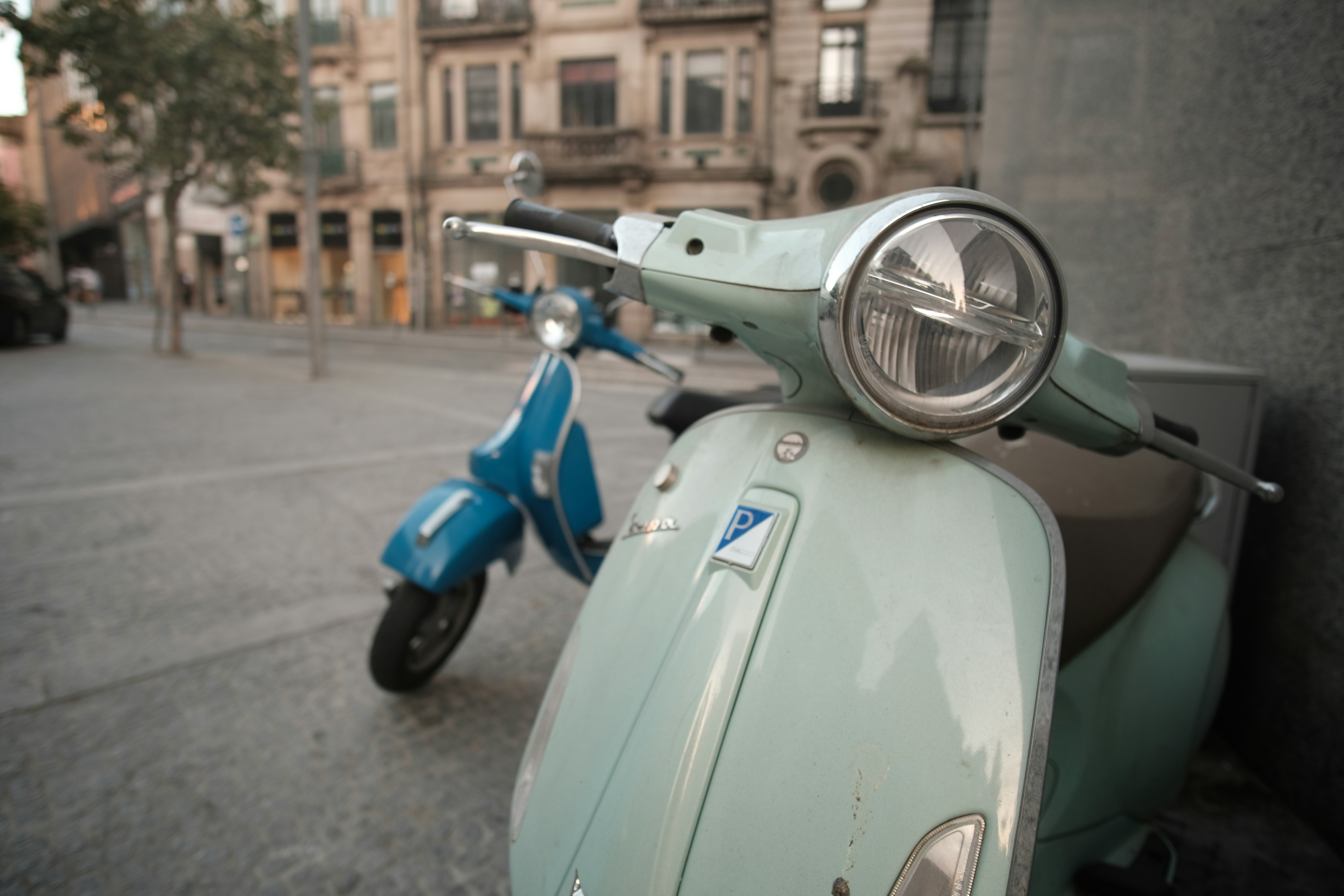 A blue scooter parked on the side of a street photo Free Portugal