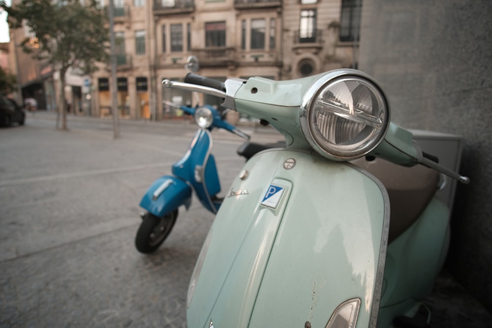 a blue scooter parked on the side of a street