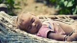 A serene outdoor scene with a baby peacefully napping in a stroller.