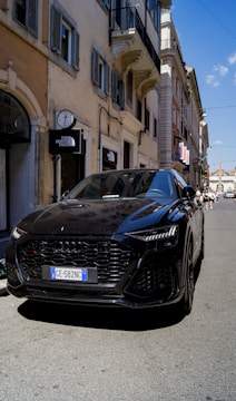 A stylish Audi A4 Avant cruising through a European city street.