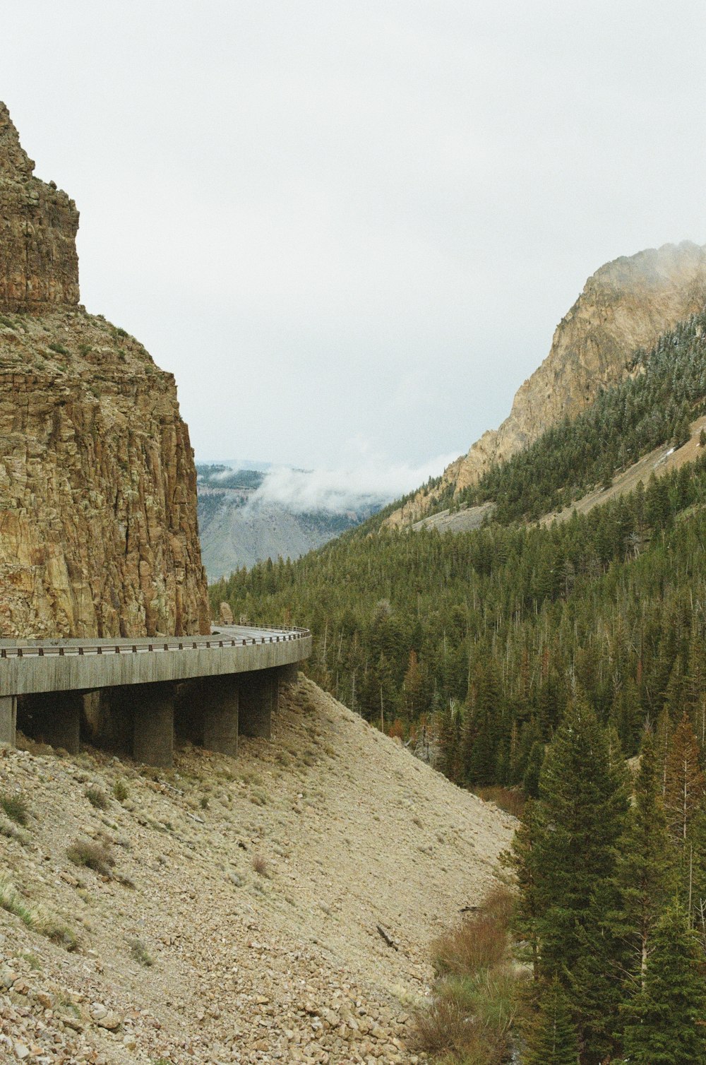 a train on a bridge over a mountain