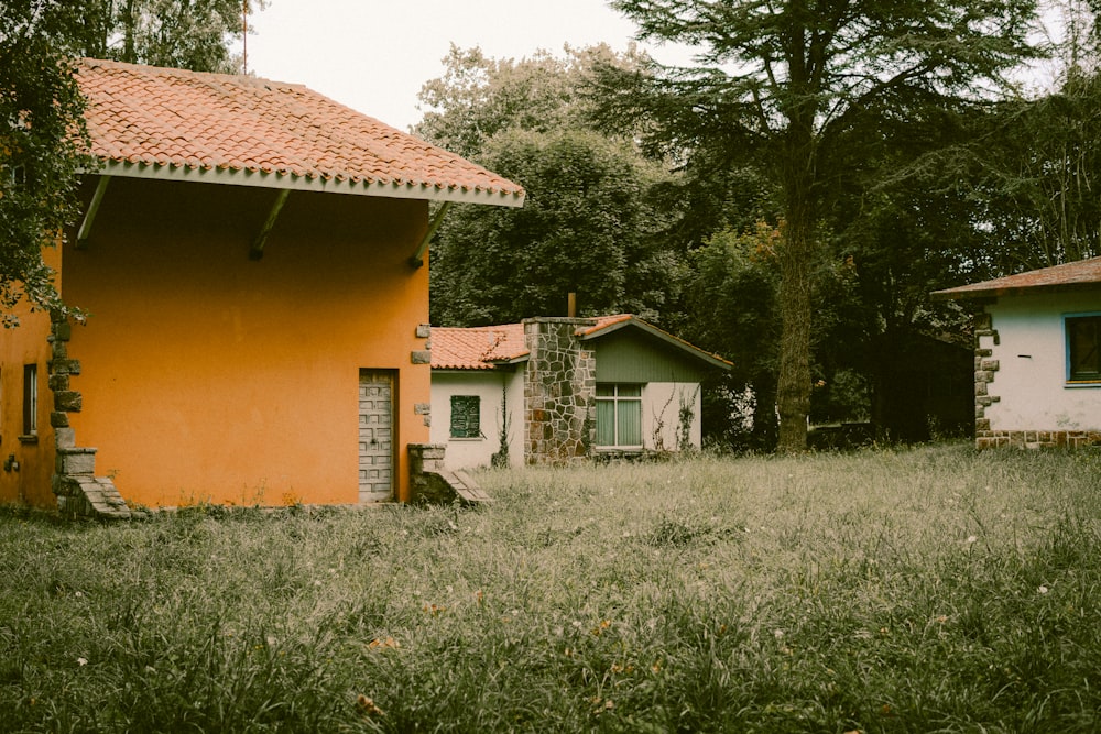 a yellow house with a red roof