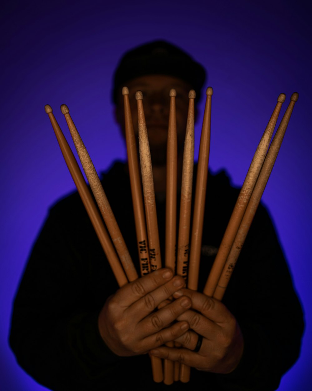 a person holding a group of baseball bats