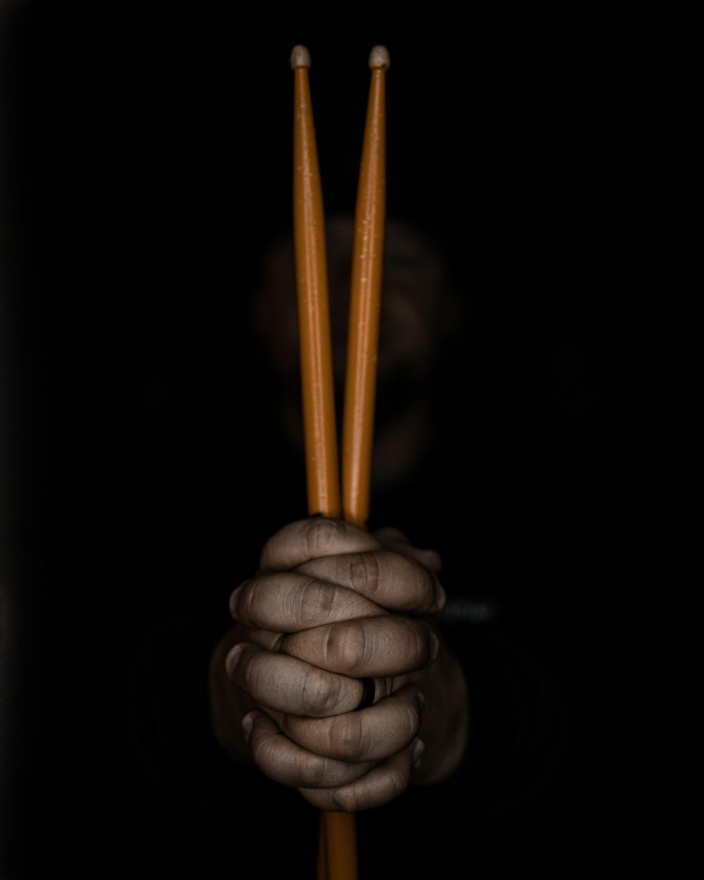 a hand holding a lit matchstick