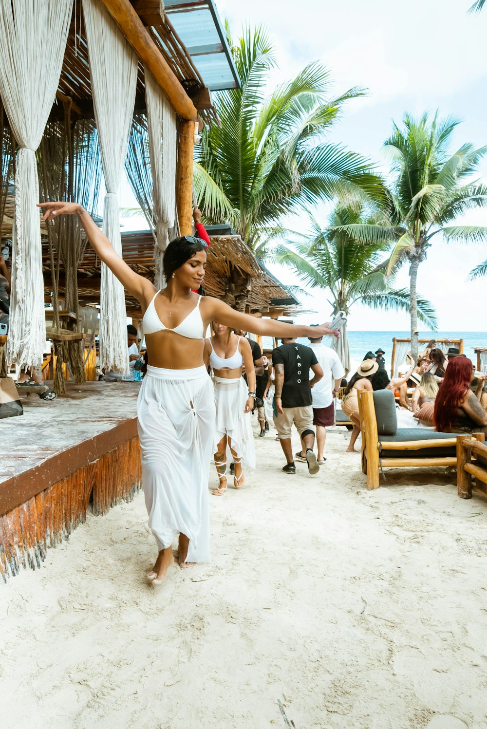 a person in a white dress on a beach