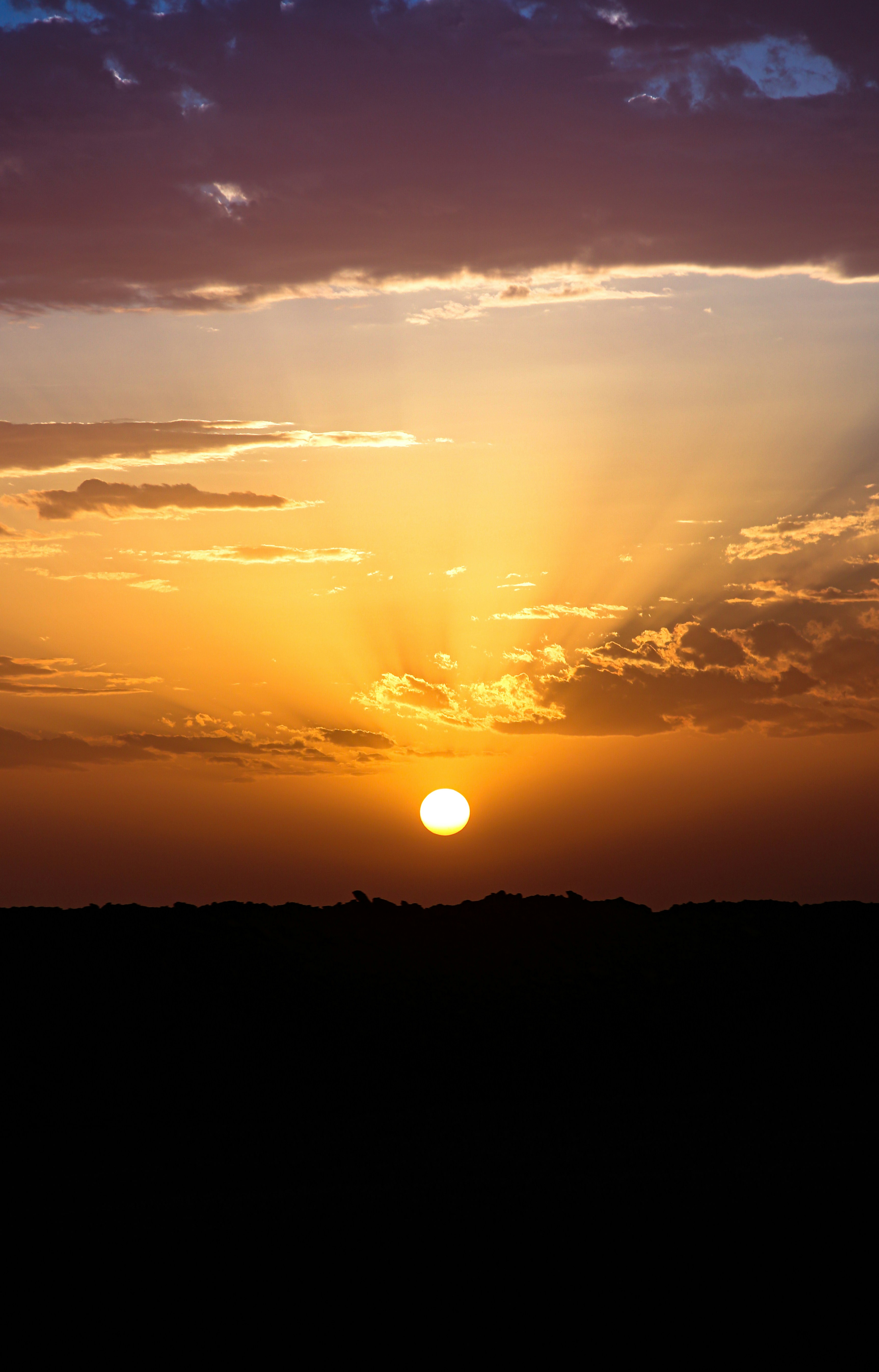 a sunset over a field