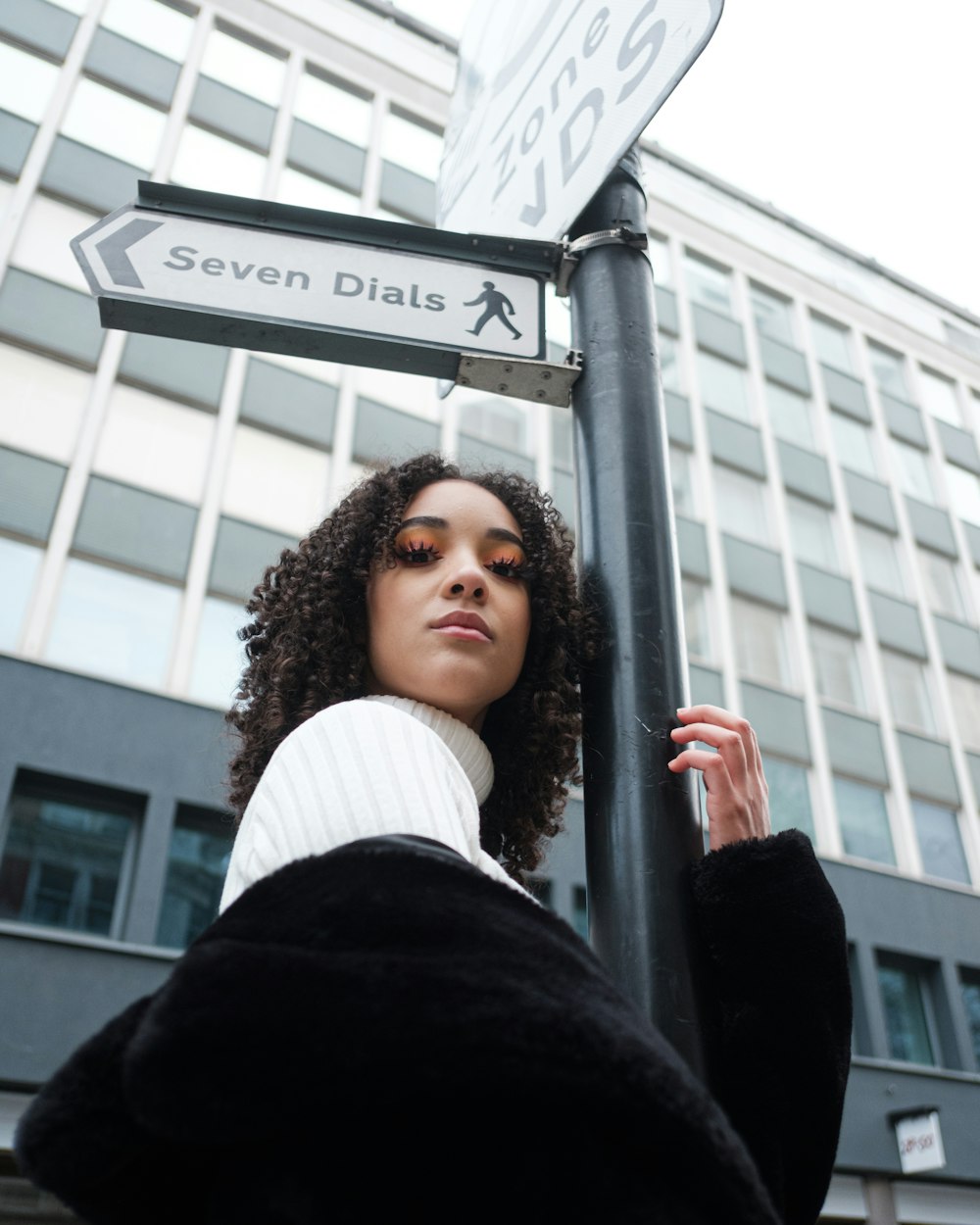 a person holding a street sign