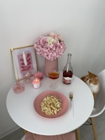 A cozy breakfast setting with a pink theme and delicious food.
