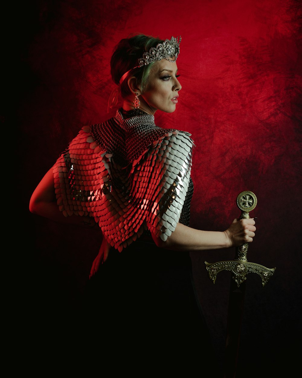 a woman wearing armour holding a sword
