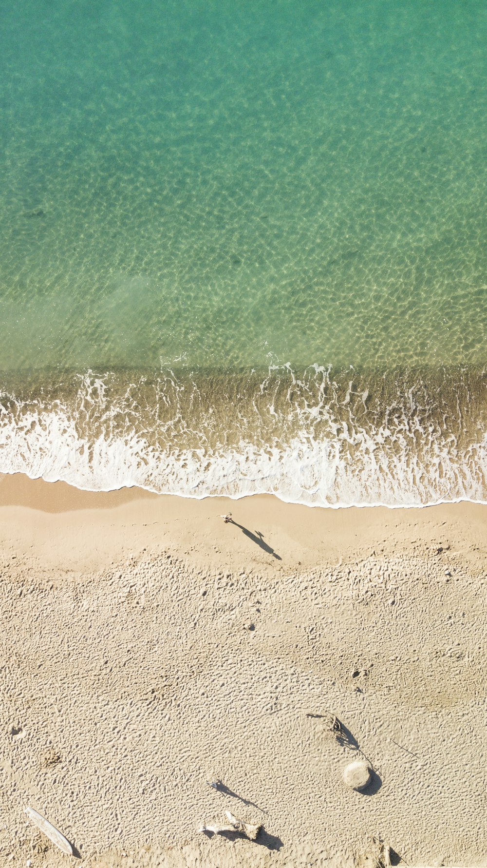 a sandy beach with waves crashing