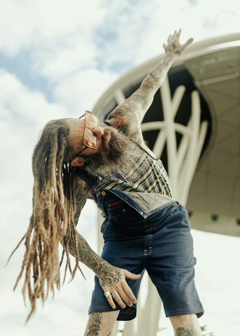 a man with long hair and glasses