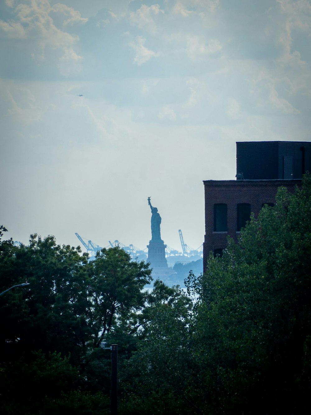 a statue of liberty and some trees