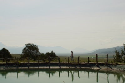 A calm outdoor scene with a person walking on a nature trail.
