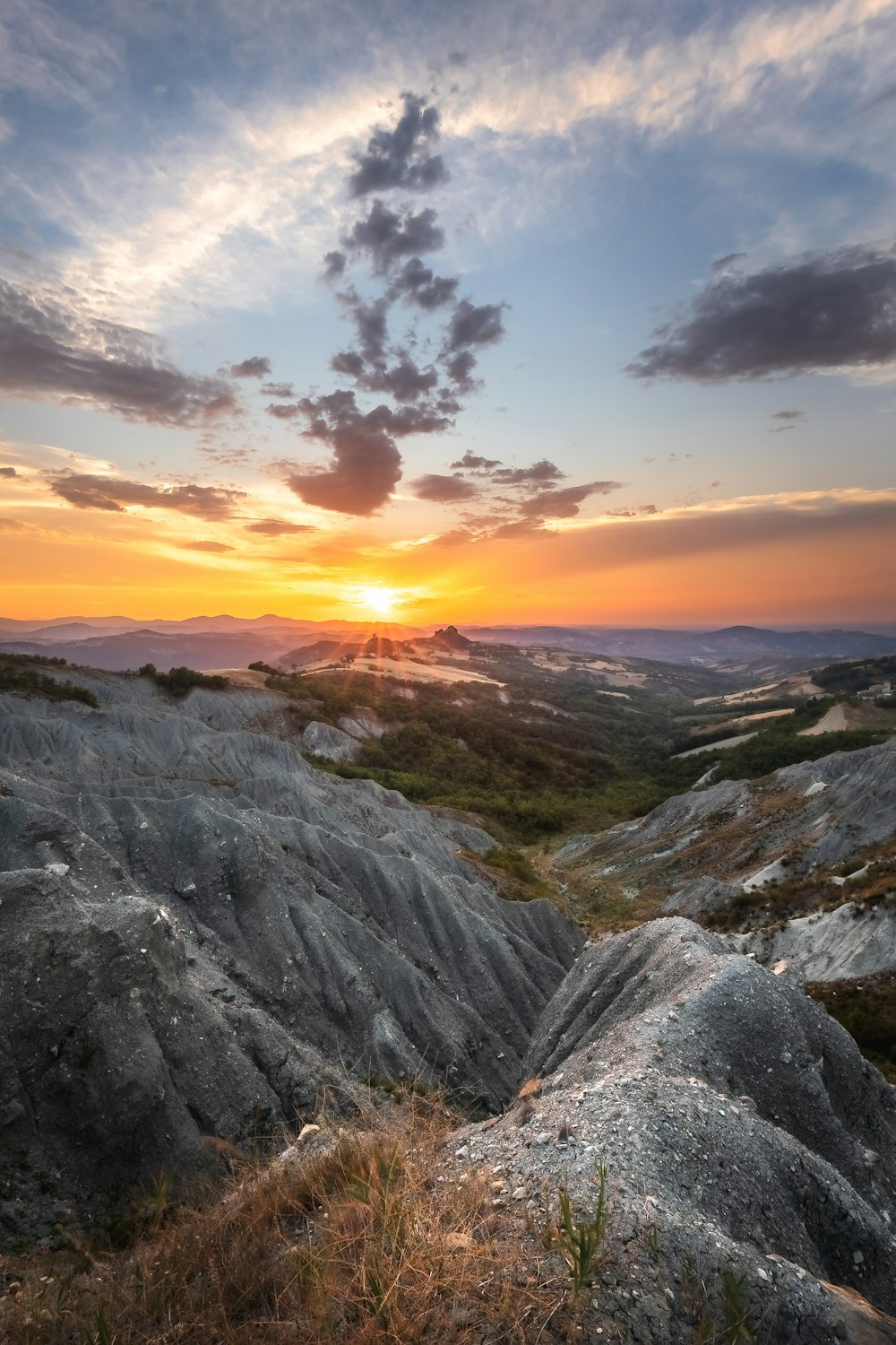 a sunset over a rocky landscape
