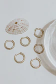 Collection of lace earrings arranged artistically with soft shadows evoking Florence’s warm light.