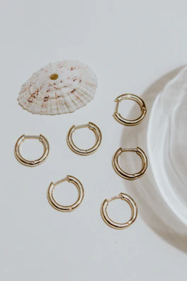 Collection of lace earrings arranged artistically with soft shadows evoking Florence’s warm light.