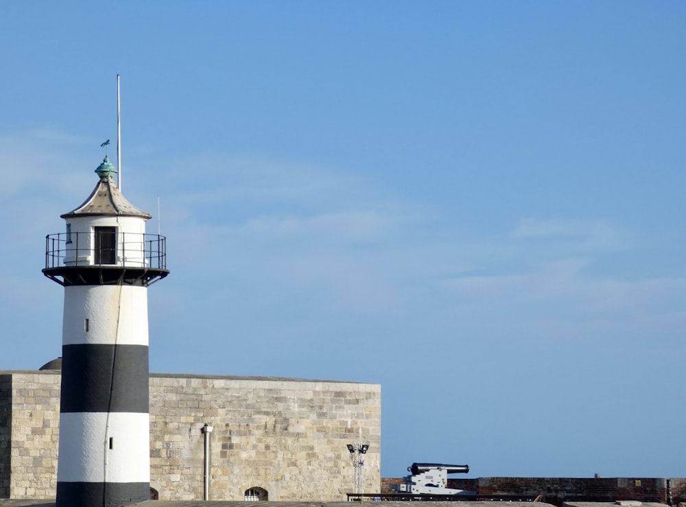 a lighthouse on a stone wall