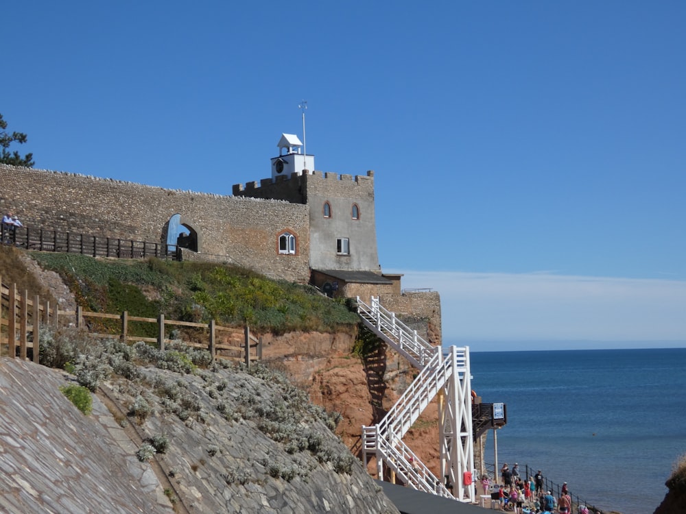 a castle on a cliff by the water