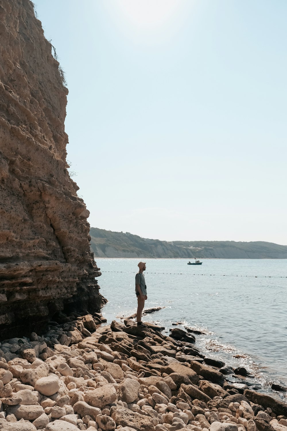 a man standing on a rocky beach